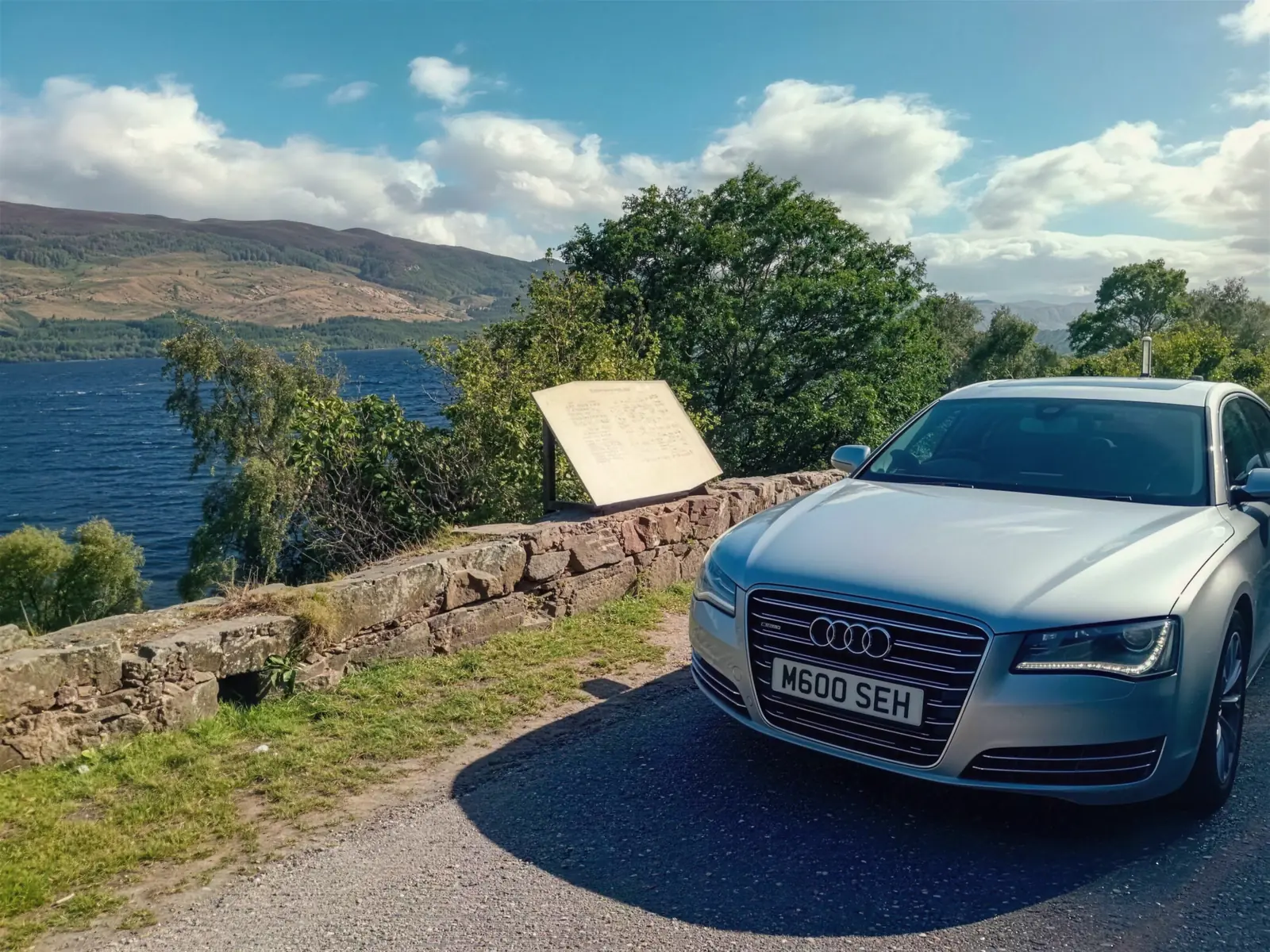 Silver Audi A8 L parked at a Highland loch viewpoint